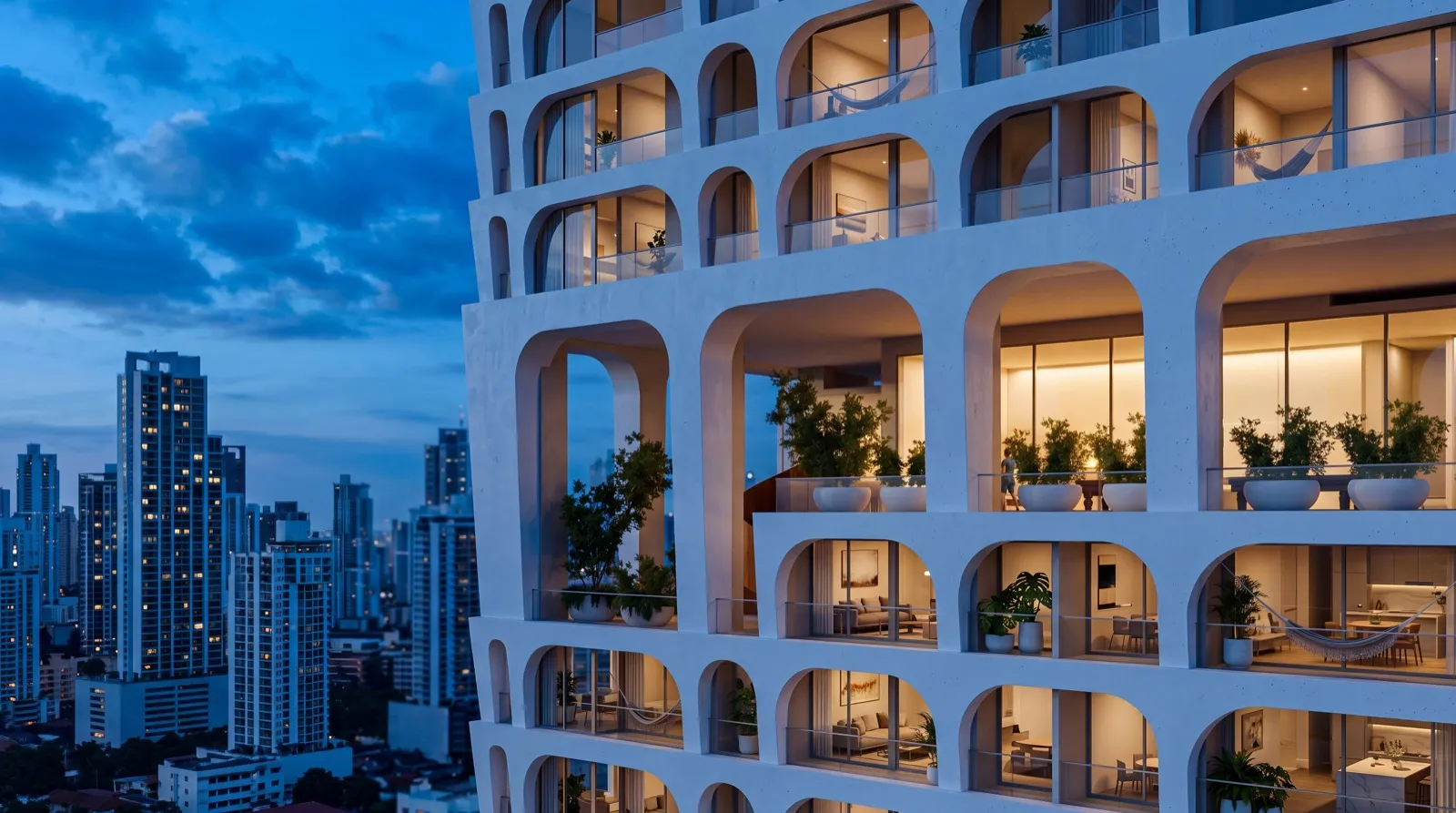 Fachada de la torre BLUR al anochecer, con balcones en arco iluminados sobre el skyline de San Francisco